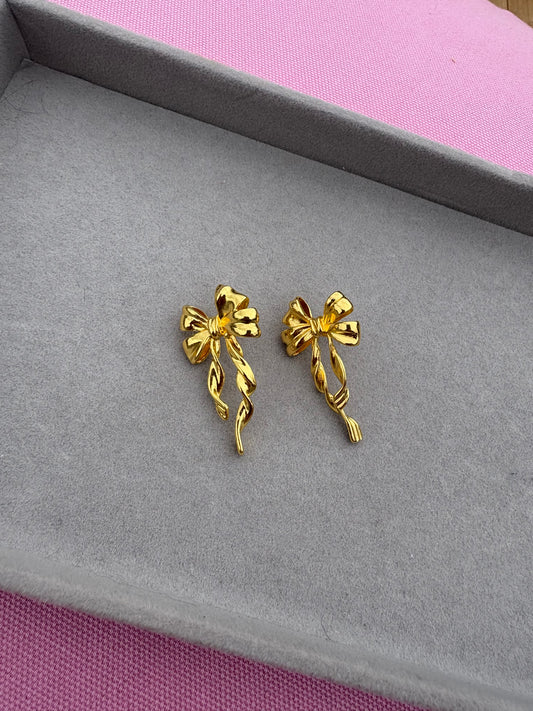 Long gold bow earrings